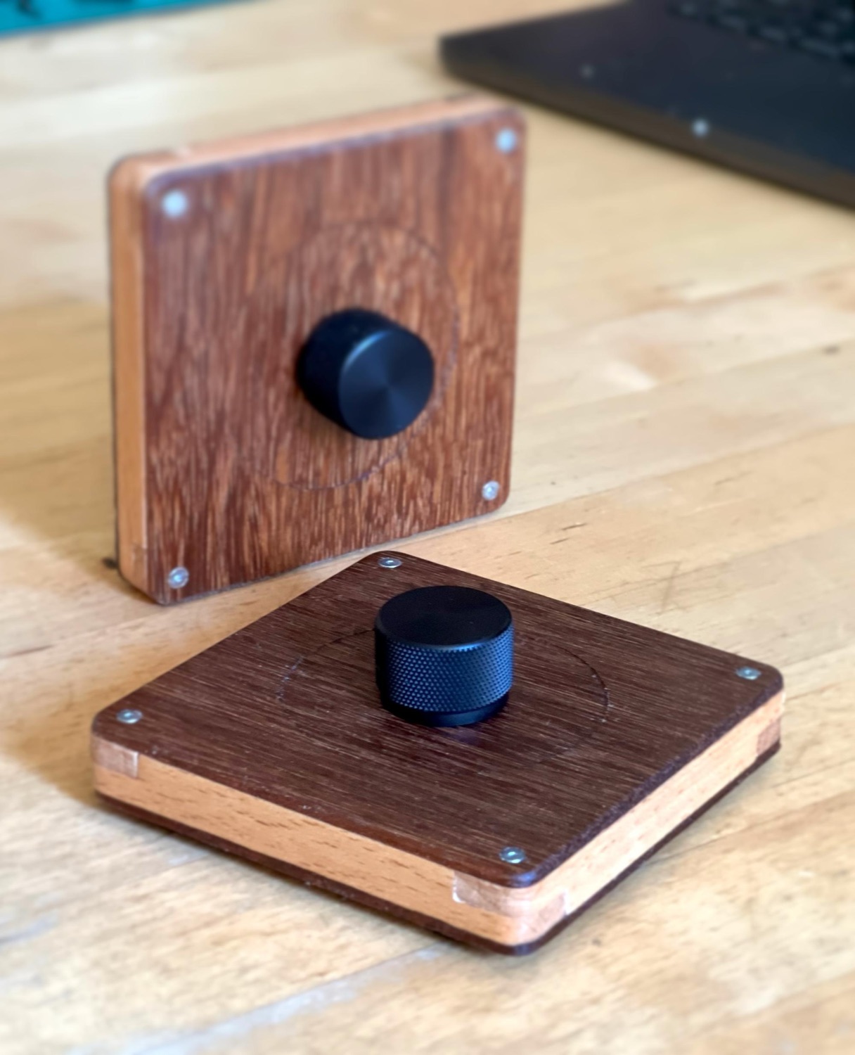 Two handcrafted TrigOne Mini controllers shown in different orientations